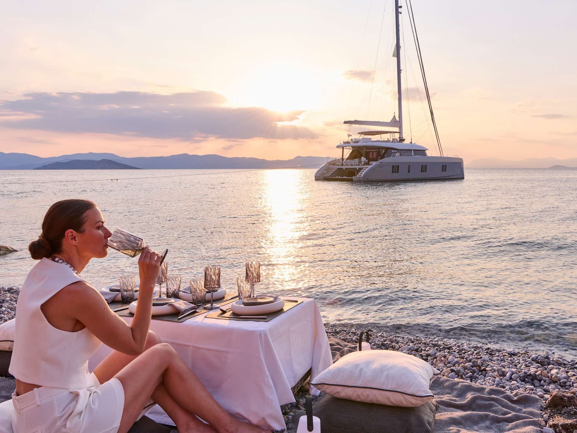 above and beyond excursion woman wine beach boat sunset